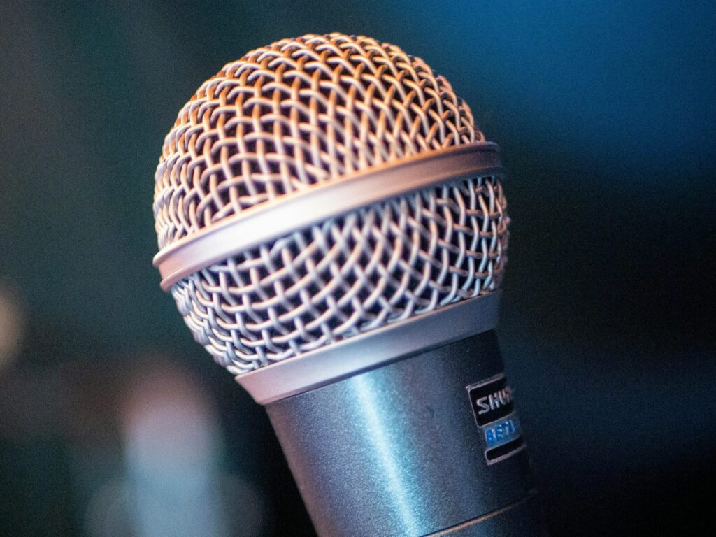 Detailed view of a performance microphone in an indoor setting.